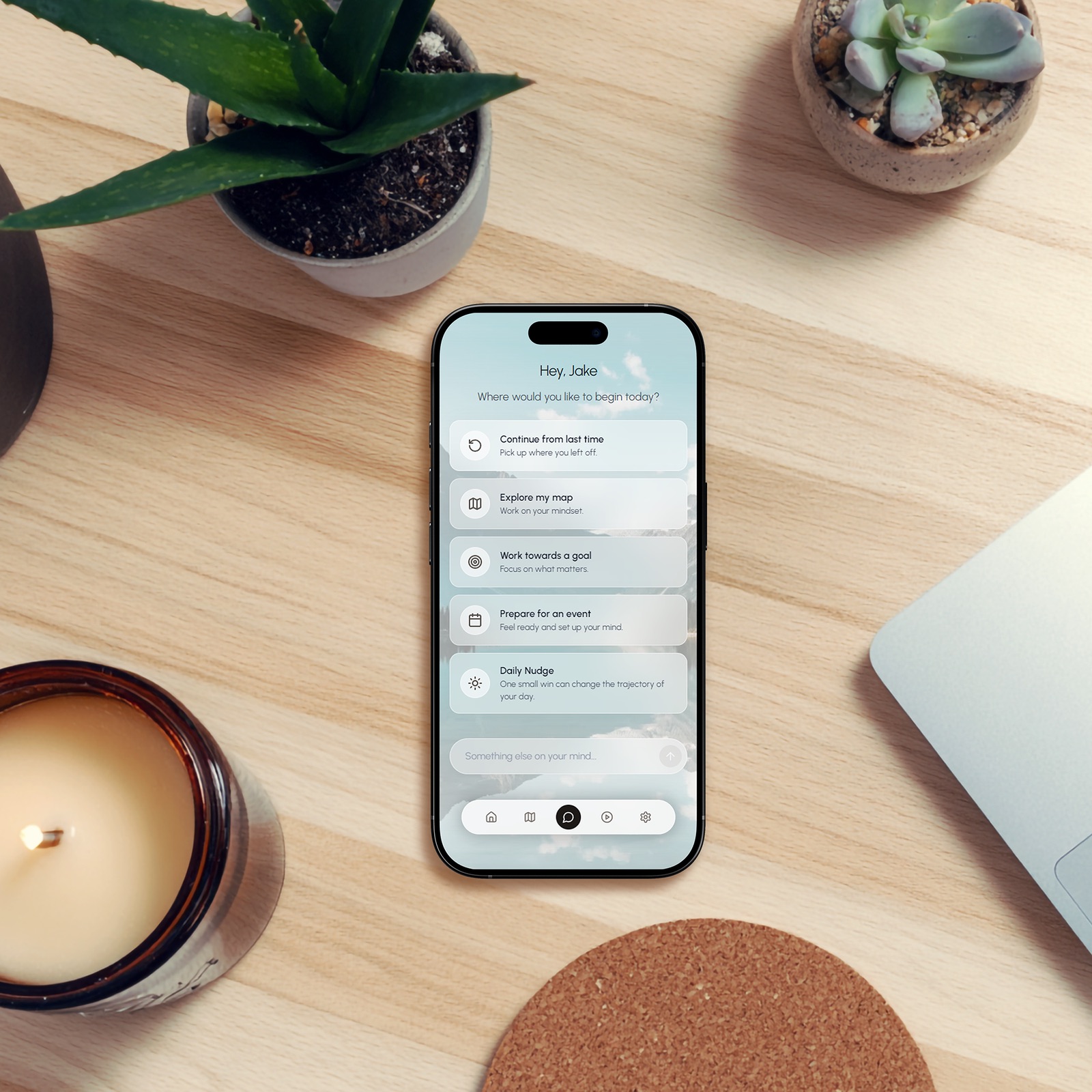 Smartphone on a desk showing the MindsetOS coaching app